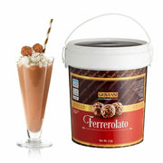 A tall glass of chocolate milkshake with whipped cream, two truffles, and a striped straw sits next to a 5kg tub labeled "Ferrerolato Gourmet Spread," beautifully adorned with images of indulgent truffles.