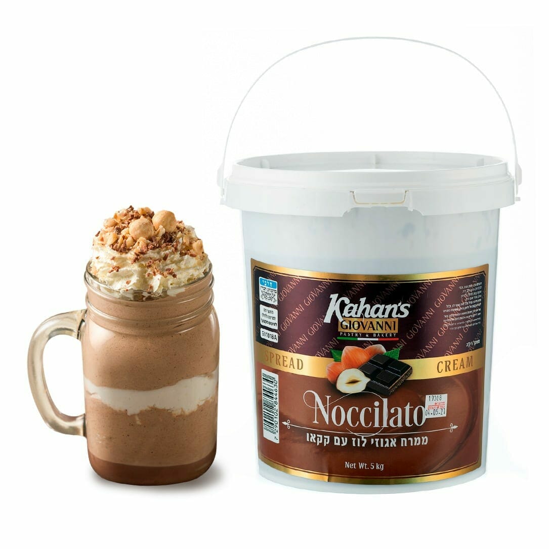 A glass jar with a handle contains layers of gourmet chocolate hazelnut spread and cream, topped with whipped cream and crushed nuts, beside a large white 5kg bucket labeled "Chocolate Hazelnut Gourmet Spread" with images of chocolate, hazelnuts, and a cake slice.