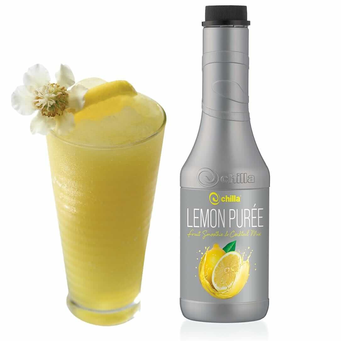 A tall glass of refreshing Chilla Lemon Ice Tea, garnished with a lemon slice and white flower, sits beside a gray bottle labeled "Chilla Lemon Ice Tea Concentrate 1lt," adorned with vibrant lemon images.