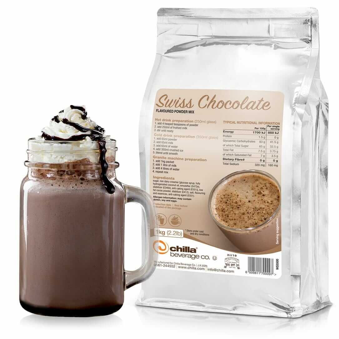 A mason jar filled with hot chocolate, topped with whipped cream and chocolate drizzle, sits beside a 1kg bag of Chilla Swiss Chocolate Powder. The clear bag shows nutritional info, a drink image, and the "Chilla Beverage Co." logo.